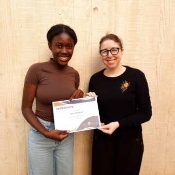 Image of an intern receiving her certificate for helping Law Access