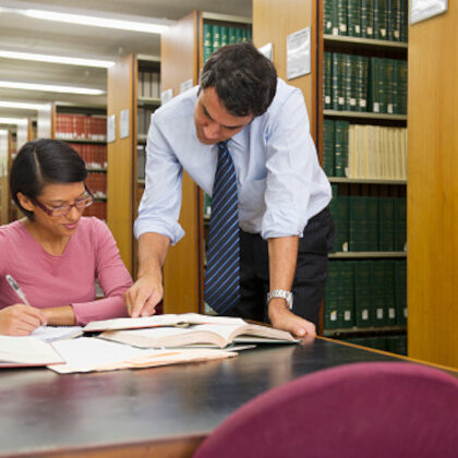Businessman and woman doing research in library